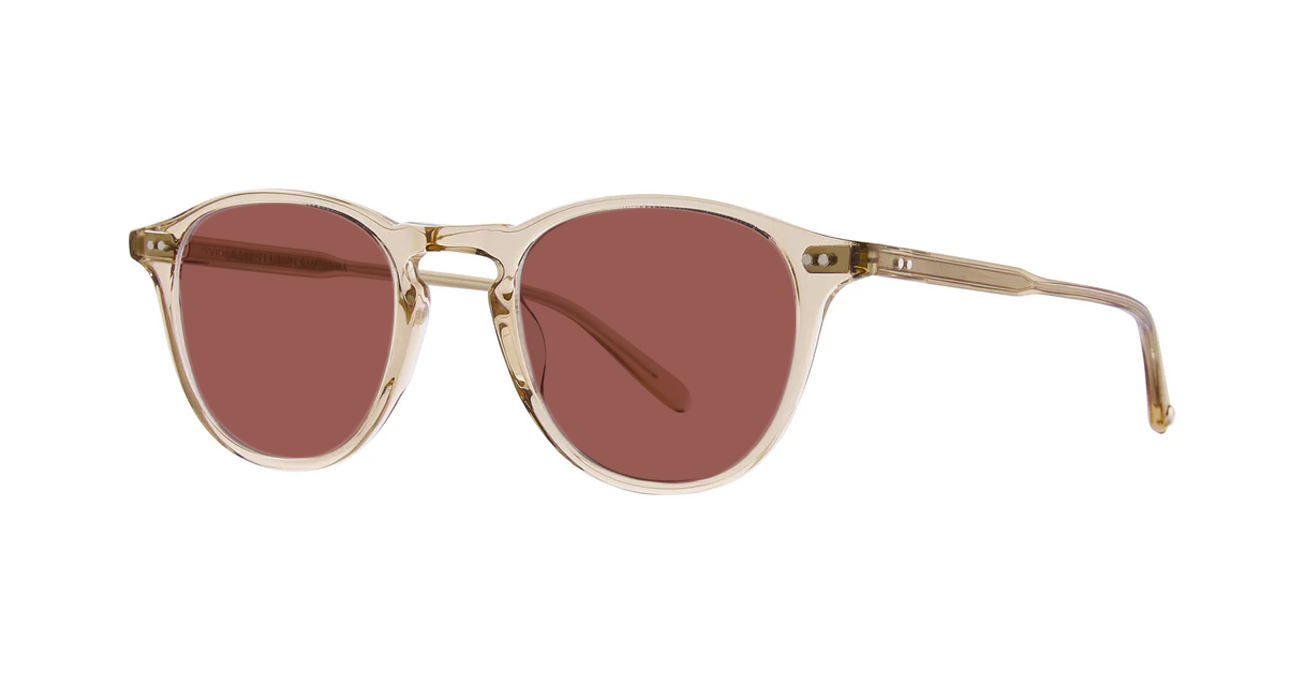 Sunglasses with pink lenses and translucent light brown frames on a white background