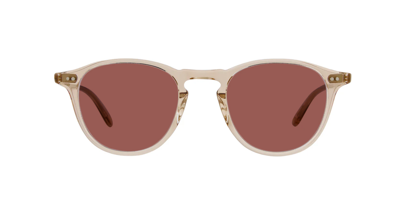 Sunglasses with pink lenses and translucent light brown frames on a white background
