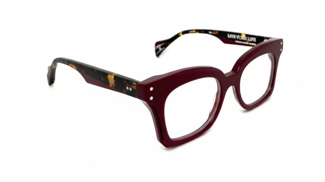 Red eyeglasses with a brand logo on a white background