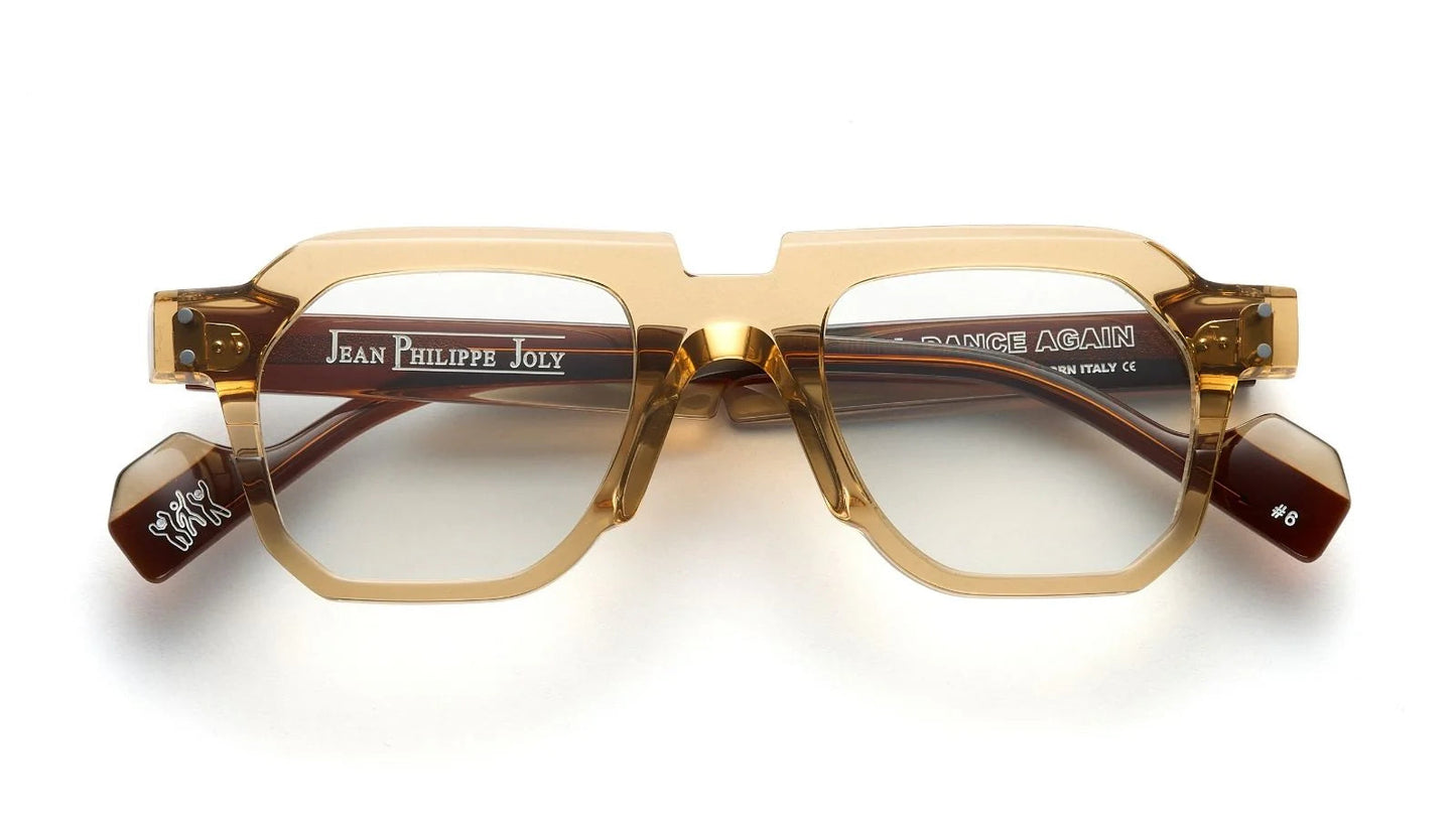 Pair of eyeglasses with gold frame and 'Jean Philippe Joly' branding on a white background