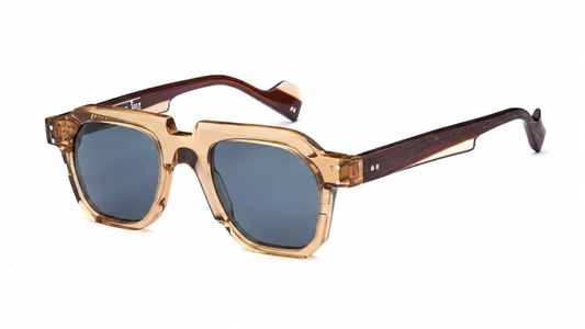 Oversized square sunglasses with a translucent amber-tinted frame, dark brown temples, and blue-gray tinted lenses, shown on a plain white background.