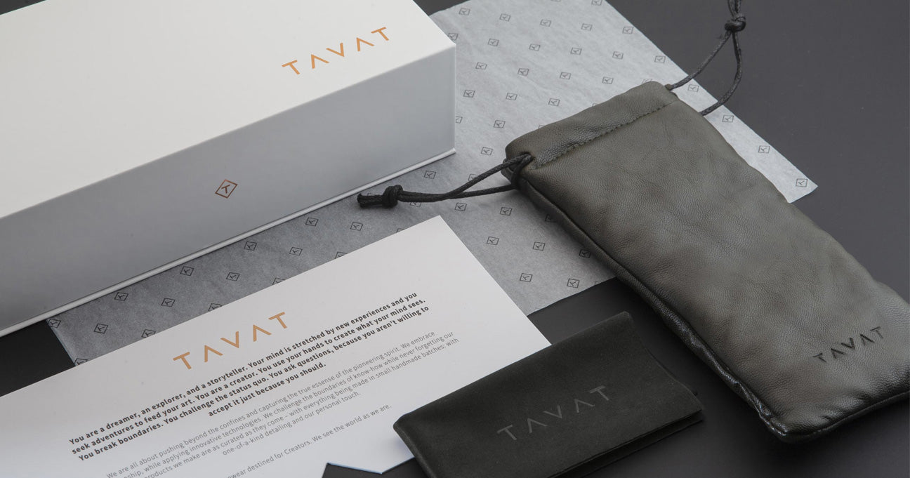 TAVAT branded sunglasses case with packaging and accessories on a gray surface
