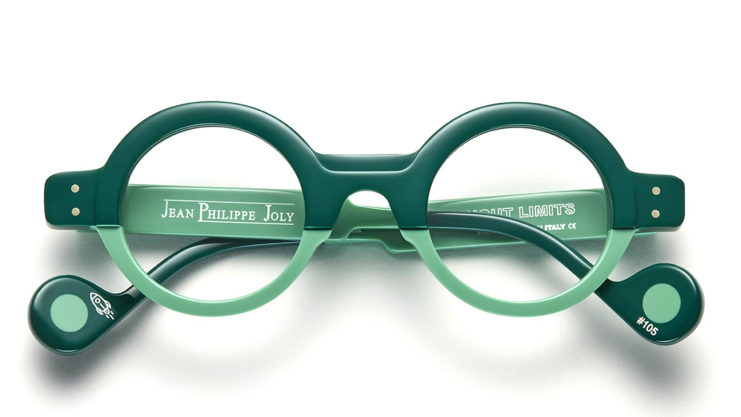 Green eyeglasses with 'Jean Philippe Joly' branding on a white background