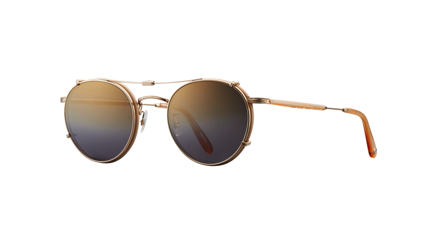 Side view of a gold Garrett Leight stainless steel folding sun clip with mirror lenses, designed to attach to Wilson eyeglasses, displayed against a plain background.