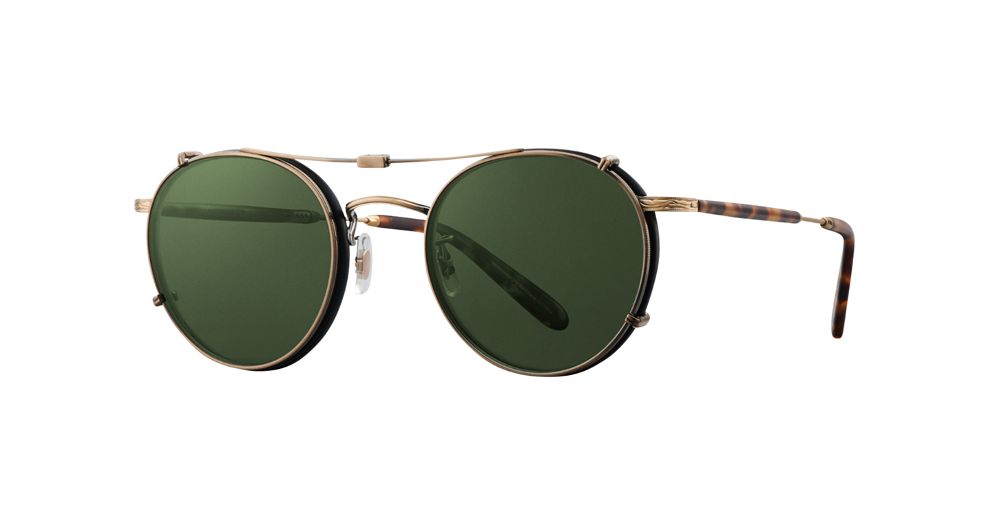 Side view of an antique gold Garrett Leight stainless steel folding sun clip with green tinted lenses, designed to attach to Wilson eyeglasses, displayed against a plain background.