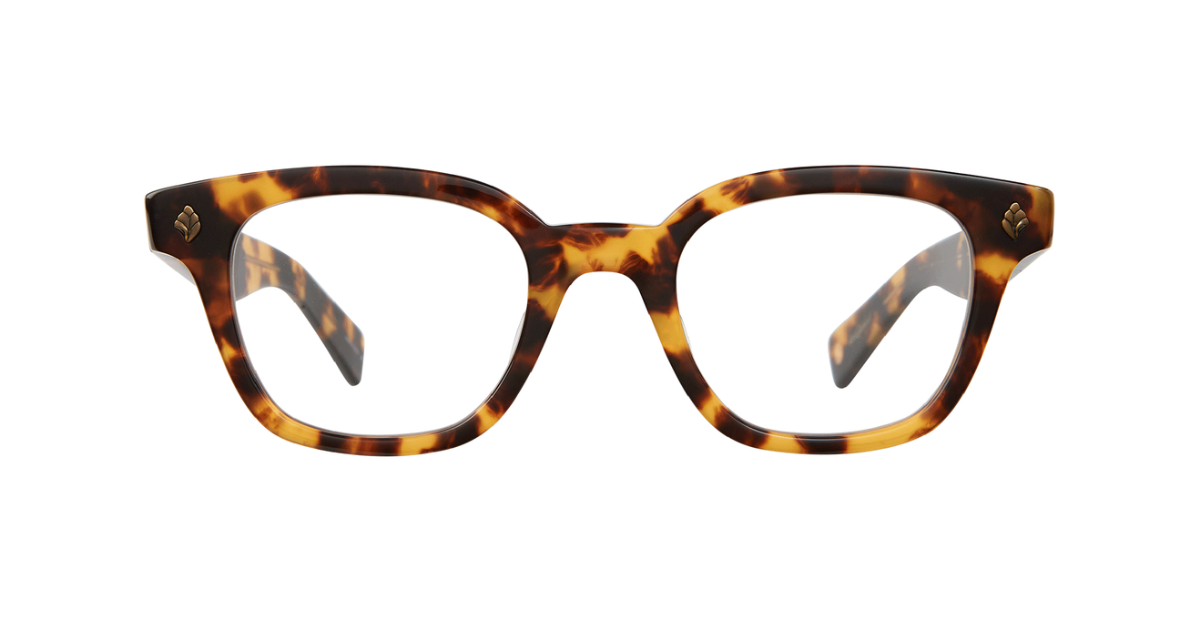 With rich materials and a bold silhouette, the Naples Bio Spotted Tortoise eyeglass frame infuses a modern design with vintage sensibility. Palm leaf plaques embellish the exaggerated end pieces for a look that's equal parts minimal and striking. Select colorways are crafted from the new bio-based acetate. Hand Finished in LA. 